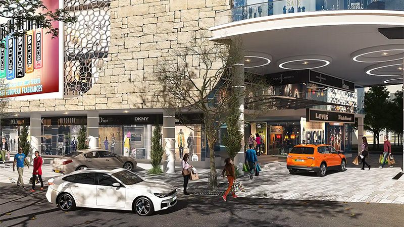 Pelican Mall street-level shopfronts with stone cladding and parked cars